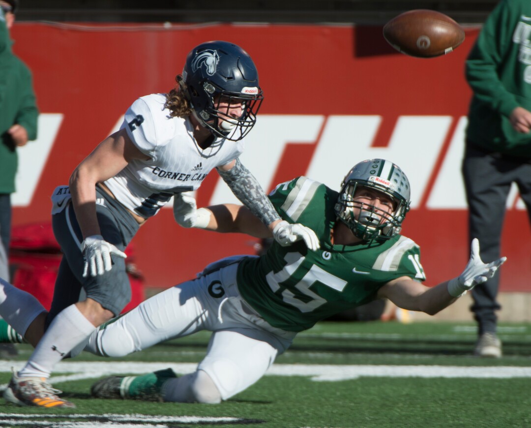 (Rick Egan  |  The Salt Lake Tribune)    Olympus receiver Noah Bennee stretches to try to catch a pass, as Corner Canyon defensive back, John Scheffner defends for the Chargers, in 5A football semifinal action between Olympus and Corner Canyon at Rice-Eccles Stadium, Thursday, Nov. 8, 2018.