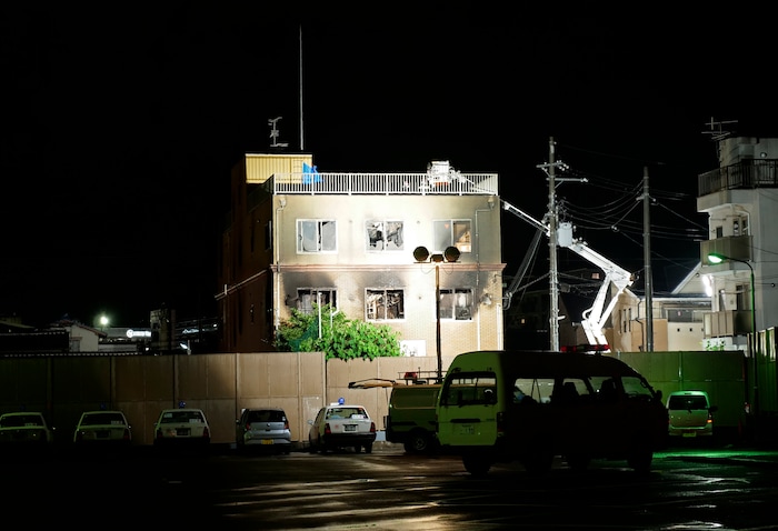(Hiromi Tanoue | AP Photo) Light is cast on the building of Kyoto Animation following a fire in Kyoto, western Japan, Thursday, July 18, 2019. The fire broke out in the three-story building in Japan's ancient capital of Kyoto, after a suspect sprayed an unidentified liquid to accelerate the blaze, Kyoto prefectural police and fire department officials said.