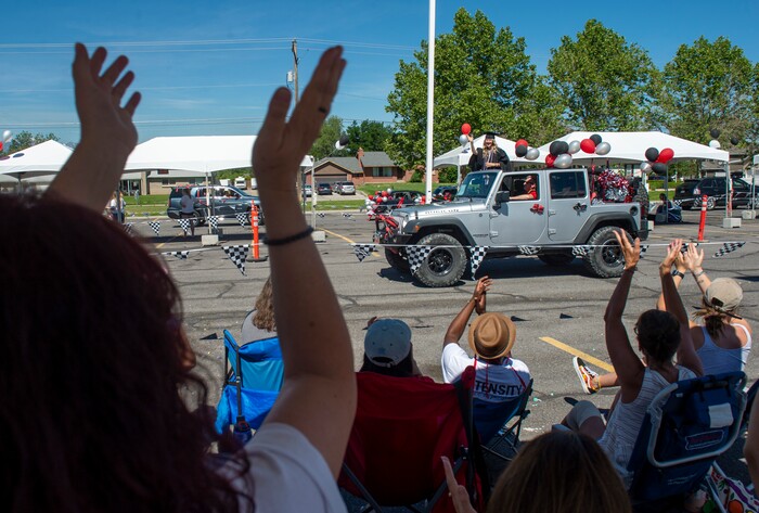(Rick Egan  |  The Salt Lake Tribune)      Faculty and staff at Alta High cheer as the parade of 2020 graduates drive by in a “drive through” graduation ceremony at Alta High, Thursday, May 28, 2020.