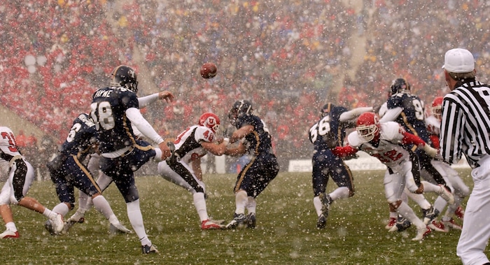 (Trent Nelson  |  Tribune file photo)  BYU's Matt Payne punts the ball in heavy snowfall during the game BYU, Utah game on Saturday November 22, 2003 at LaVell Edwards Stadium.