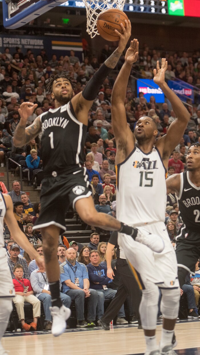 (Rick Egan  |  The Salt Lake Tribune) Brooklyn Nets guard D'Angelo Russell (1) scores on a revers layup, as Utah Jazz forward Derrick Favors (15) defends, in NBA action, Utah Jazz vs. Brooklyn Nets, in Salt Lake City, Saturday, November 11, 2017.