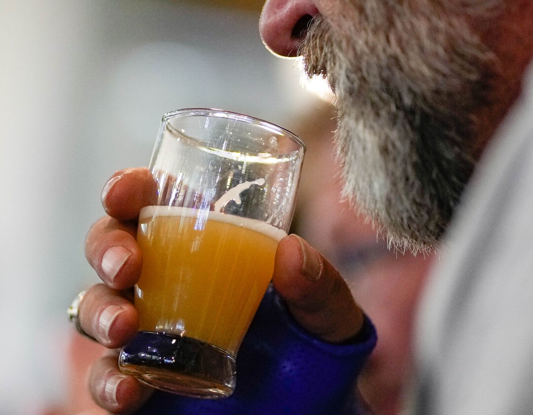 (Francisco Kjolseth | The Salt Lake Tribune) Dane Hofmann smells the aroma of apricot in a beer at Hopkins Brewery in Salt Lake City during the start of a City Brew Tour in Salt Lake City on Saturday, April 30, 2022. 