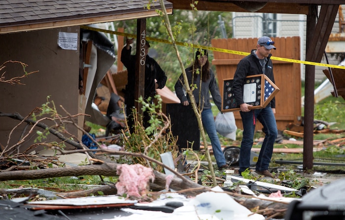 (Benjamin Zack | Standard-Examiner via AP) Wesley, right, and Rose Blomquist pull a few personal items out of their tornado damaged home in Washington Terrace, Utah on Friday morning, Sept. 23, 2016. Rose was in the home on Thursday when the tornado hit. She says the last thing she saw was her grill hovering in midair in the backyard before she dived to the kitchen floor. Within a few seconds, her windows exploded and a large tree came down on her roof.