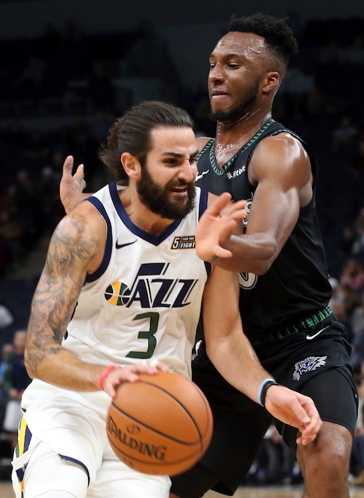 Utah Jazz's Ricky Rubio, left, of Spain, drives as Minnesota Timberwolves' Josh Okogie, of Nigeria, defends during the first half of an NBA basketball game Wednesday, Oct. 31, 2018, in Minneapolis. (AP Photo/Jim Mone)