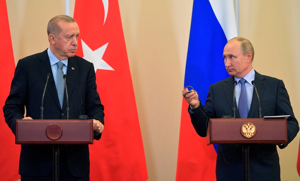 Russian President Vladimir Putin, right, and Turkish President Recep Tayyip Erdogan look at each other during a joint news conference after their talks in the Bocharov Ruchei residence in the Black Sea resort of Sochi, Russia, Tuesday, Oct. 22, 2019. Erdogan says Turkey and Russia have reached a deal in which Syrian Kurdish fighters will move 30 kilometers (18 miles) away from a border area in northeast Syria within 150 hours. (Alexei Druzhinin/Sputnik Kremlin Pool Photo via AP)