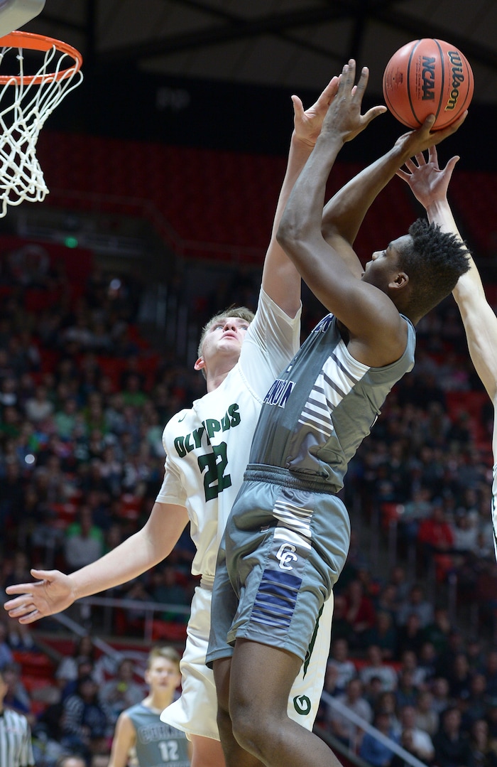 (Leah Hogsten | The Salt Lake Tribune) Olympus' Spencer Jones (22) stops Corner Canyon's Josh Christensen (03). Olympus defeated Corner Canyon 76-49 to win the 5A High School BoysÕ Basketball Tournament Championship at the Jon M. Huntsman Center in Salt Lake City, Saturday, March 3, 2018.