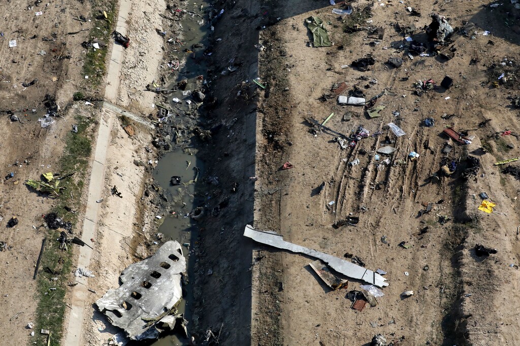 (Ebrahim Noroozi | AP) In this Wednesday, Jan. 8, 2020 photo, wreckage from a Ukrainian plane is seen on the ground and inside a water canal in Shahedshahr, southwest of the capital Tehran, Iran. Iran on Friday denied Western allegations that one of its own missiles downed a Ukrainian jetliner that crashed outside Tehran, and called on the U.S. and Canada to share any information they have on the crash, which killed all 176 people on board.