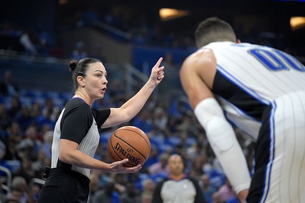FILE - In this Oct. 18, 2017, file photo, official Lauren Holtkamp gestures in front of Orlando Magic forward Aaron Gordon during the first half of an NBA basketball game against the Miami Heat, in Orlando, Fla. The G League season opens Friday night, Nov. 3, 2017, and there will be someone on the court in places like Grand Rapids or Greensboro or Des Moines whose next job will be in the NBA. That isn't limited to players. Or to men. Nearly one-third of the referees in the G League this season are women, and some _ like dozens of players, coaches, front-office staff and refs _ are moving closer to realizing NBA hopes. (AP Photo/Phelan M. Ebenhack, File)