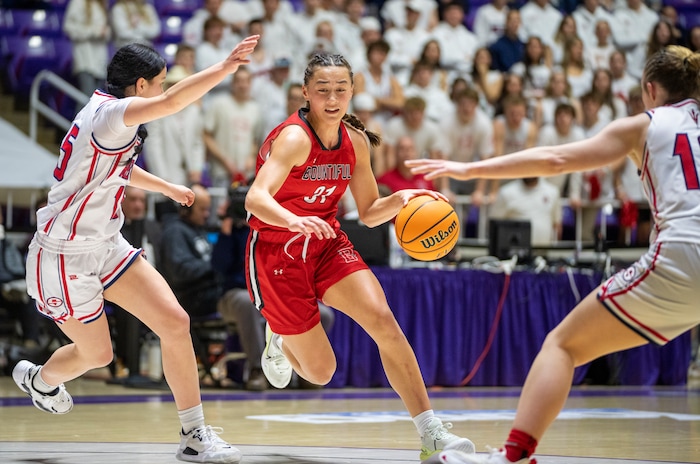 (Rick Egan | The Salt Lake Tribune) Bountiful Redhawks Milika Satuala, tries to split Springville Red Devil defenders Katie Durfey and Kayla  Porray, in the Girls 5A State Championship between the Springville Red Devils and the Bountiful Redhawks, at Weber State, on Saturday, March 4, 2023.
