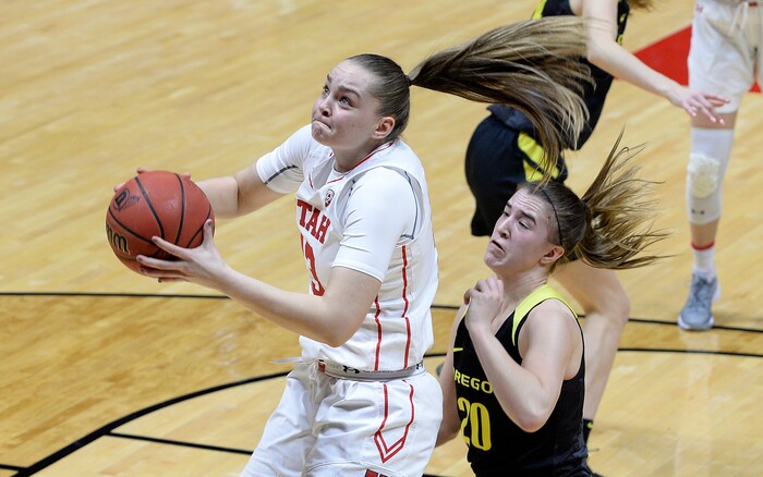 Scott Sommerdorf | The Salt Lake TribuneUtah Utes forward Megan Jacobs (13) grabs a second half rebound in front of Oregon Ducks guard Sabrina Ionescu (20). Oregon defeated Utah 84-68, Sunday, January 28, 2018.