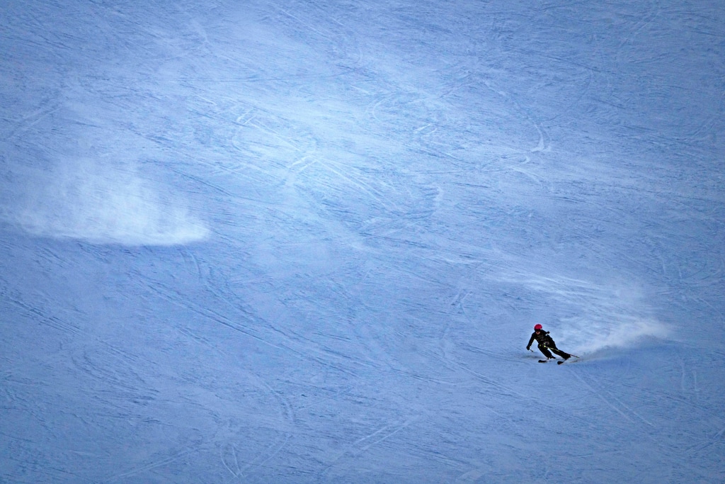 (Rick Egan | The Salt Lake Tribune) A skier makes some turns late in the day,  at Brighton Ski Resort, in December 2024. The resort has set a date to open the 2025-2026 season.