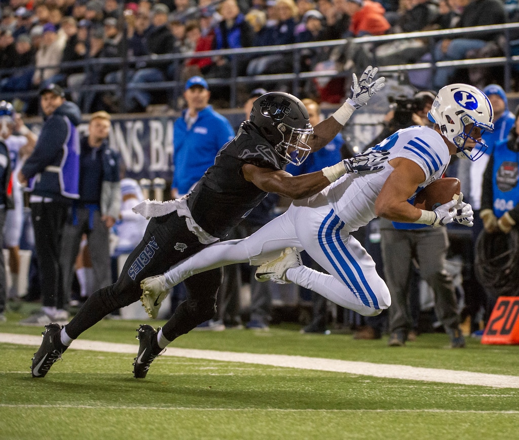 (Rick Egan  |  The Salt Lake Tribune) Brigham Young wide receiver Dax Milne (82) catches a long bomb for the Cougars under pressure from Utah State Aggies cornerback DJ Williams (7) Logan on Saturday, Nov. 2, 2019.