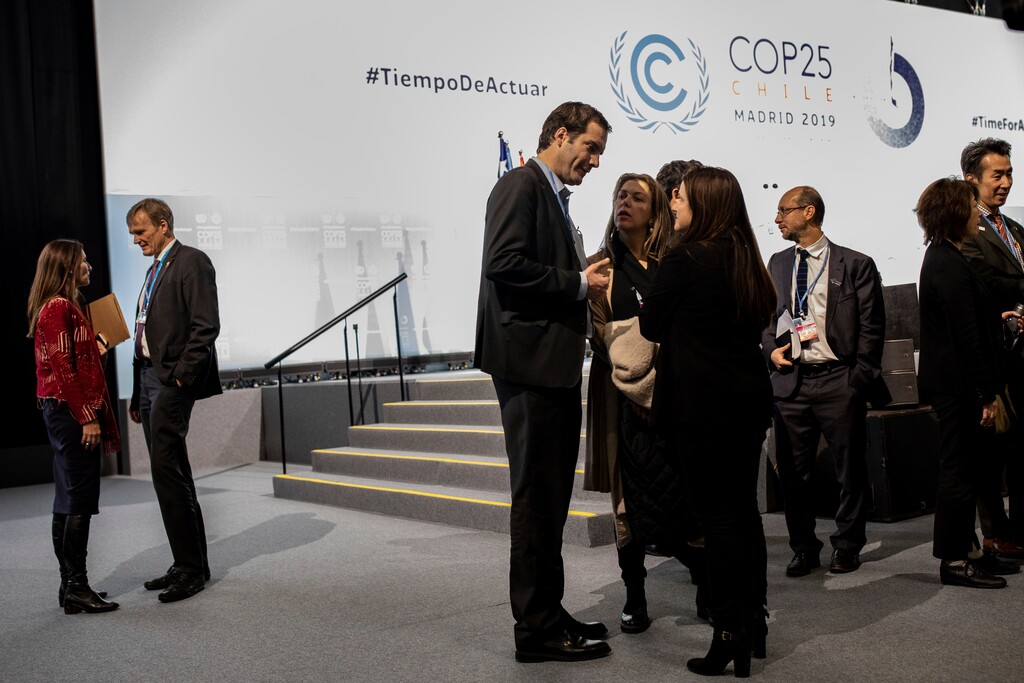 (Bernat Armangue | The Associated Press) COP25 President Carolina Schmidt, left, talks with party members during the closing plenary in Madrid, Sunday Dec. 15, 2019. Negotiators from almost 200 nations planned to gather for a final time at the U.N. climate meeting in Madrid early Sunday to pass declarations calling for greater ambition in cutting planet-heating greenhouse gases and in helping poor countries suffering the effects of climate change. But one of the key issues at the talks, an agreement on international carbon markets, has eluded officials even after the Chilean chair extended Friday's talks deadline to allow more time for negotiations.