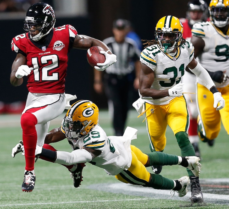 Atlanta Falcons wide receiver Mohamed Sanu (12) runs by Green Bay Packers defensive back Kentrell Brice (29) during the first of an NFL football game, Sunday, Sept. 17, 2017, in Atlanta. (AP Photo/John Bazemore)