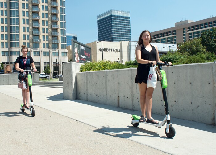 (Rick Egan  |  The Salt Lake Tribune)    Becca Emter,  and Ana Salyards, from Helena Montana, ride Lime Scooters, in downtown Salt Lake City, Monday, July 30, 2018.

 