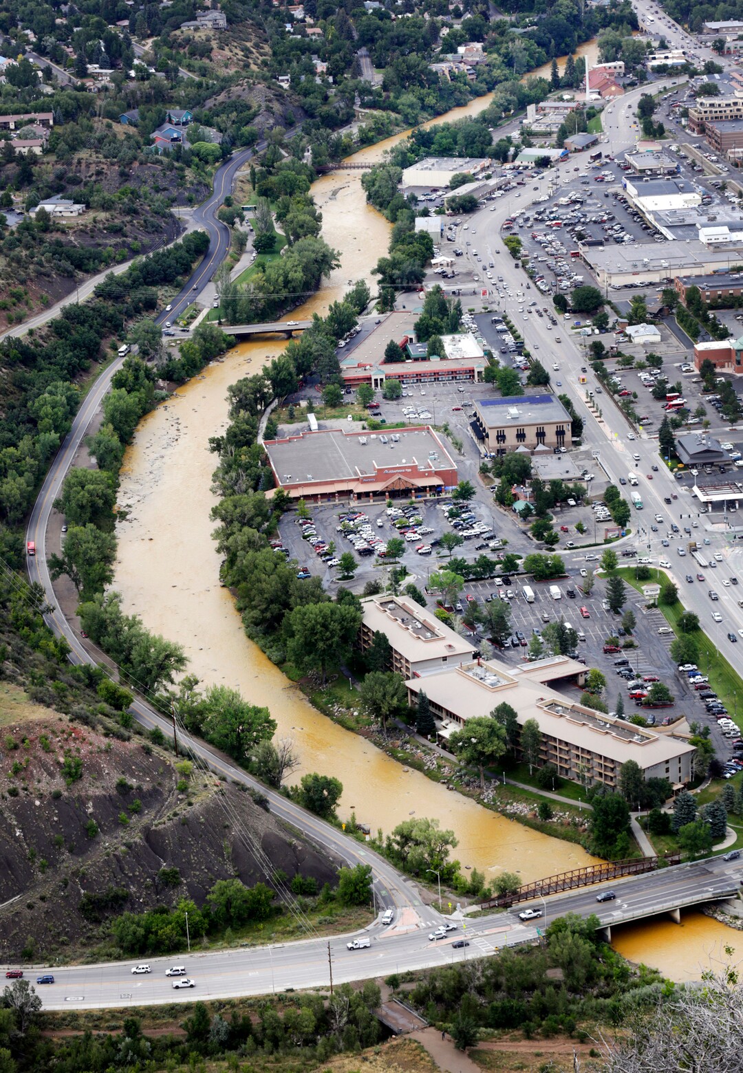 A toxic sludge flows down the Animas River through Durango Colo, on Friday, Aug. 7, 2015, after the Gold King Mine north of Silverton Colo., spilled heavy minerals into the river on Wednesday. Federal environmental officials say it's too early to know whether heavy metals that spilled into a river from a Colorado mine pose a health risk.  (Jerry McBride(/The Durango Herald via AP)