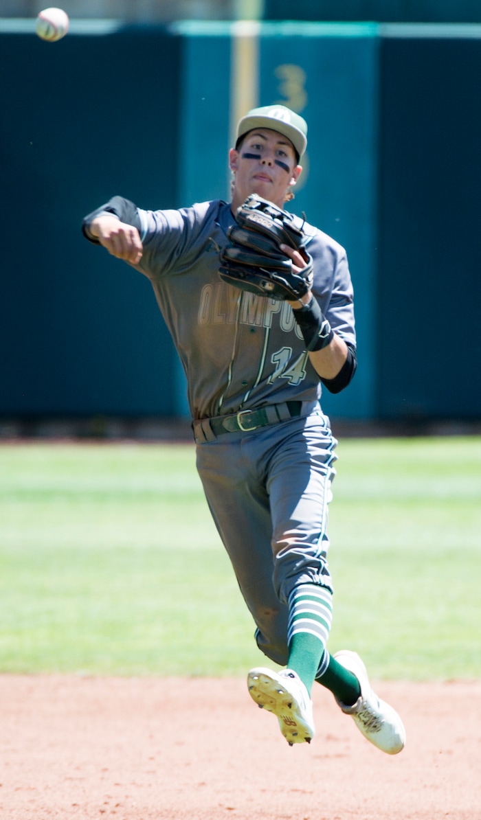 (Rick Egan  |  The Salt Lake Tribune)   Olympus short stop, Gabe Singer,  throws to first for an out, in the 5A state baseball championship game between Olympus and Jordan, at UVU in Orem, Friday, May 25, 2018.