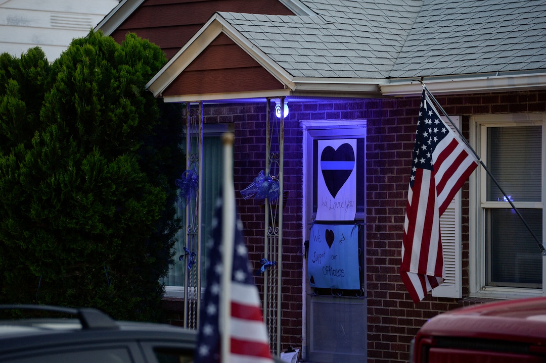 (Leah Hogsten  |  The Salt Lake Tribune) Friends and supporters lined the neighborhood of Officer Nate Lyday's childhood home on Custer Avenue in Ogden prior to the Memorial Procession and Community Vigil in honor of Lyday's life. The procession made its way through five other Ogden landmarks before ending at Lindquist Field.
