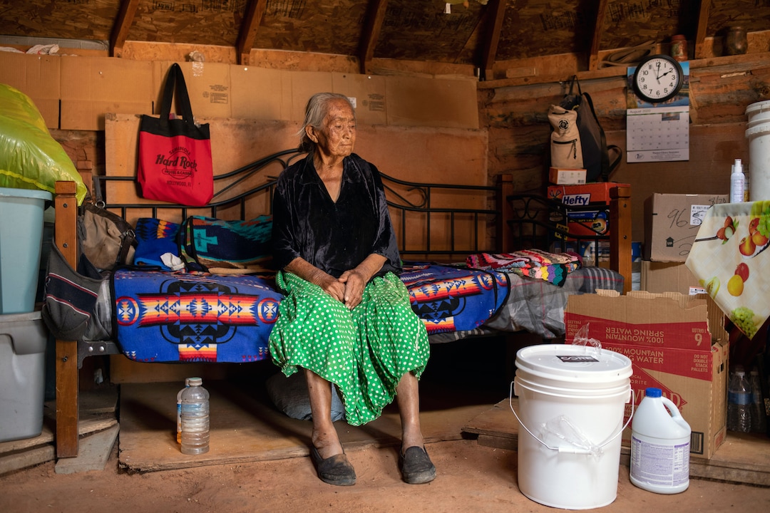 (Sharon Chischilly | The New York Times) Betty Bennett, who receives food and supplies from public health nurses, at her home near Kayenta, Ariz., on Aug. 31, 2020. Many homes in tribal communities do not have electricity or running water.