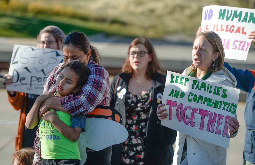 (Francisco Kjolseth  |  The Salt Lake Tribune)  Maria Santiago Garcia is embraced by her son Anthony Fajardo, 5, as community members rally in front of the Immigration and Customs Enforcement offices in West Valley City on Monday, Oct. 16, 2017, to support her. The single Utah mother of four U.S. born children faces an impending deportation order.