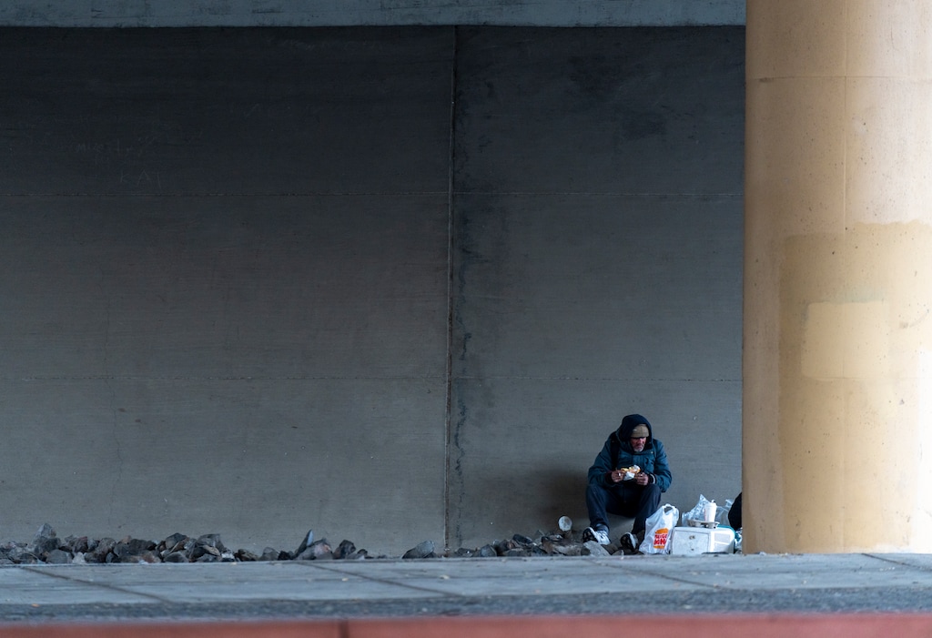 (Rick Egan | The Salt Lake Tribune)  A man seeks shelter from the snow under the overpass on North Temple, on Friday, Jan. 5, 2024.