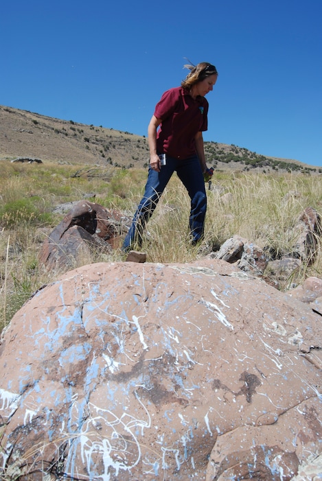 Brian Maffly  |  The Salt Lake Tribune Bekee Hotzee, who manages BLMÕs Salt Lake field office, examines rocks where target shooters blasted cans of paint.