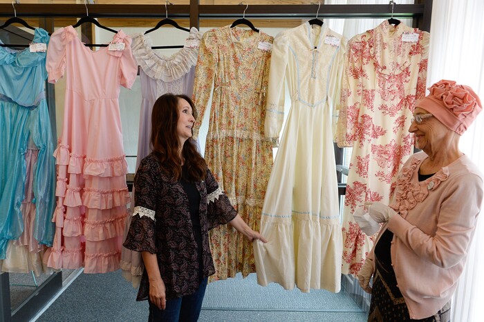 (Francisco Kjolseth  |  The Salt Lake Tribune)  Sherry Crandall, left, points out her favorite Gunne Sax dress made by her mother Nacele Hart for her and her three sisters during an exhibit of Nacele's work in Orem. 