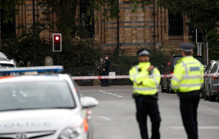 Britain's policemen stand at the scene of an incident in central London, Saturday, Oct. 7, 2017. London police say emergency services are outside the Natural History Museum in London after a car struck pedestrians. (AP Photo/Kirsty Wigglesworth)