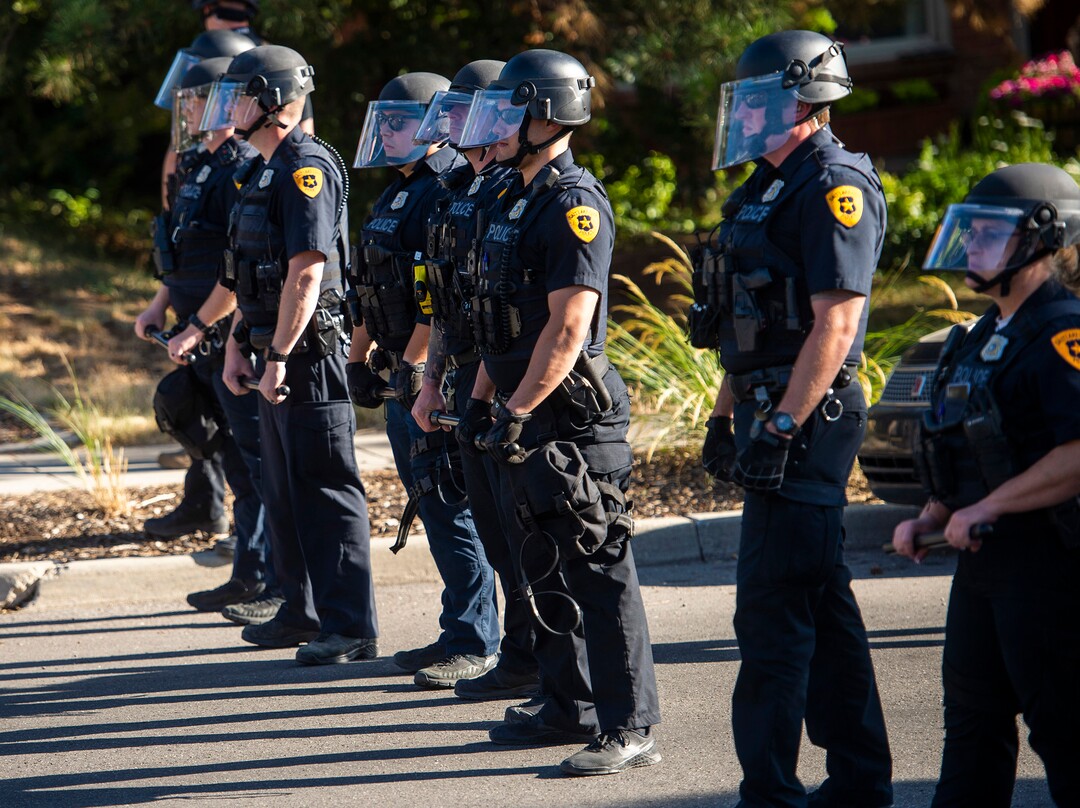 (Rick Egan  |  The Salt Lake Tribune)     Protesters are halted by a police barricade on Logan Way, near Salt Lake County Attorney Sim Gill's home, as they dance in the streets, during a march for Justice onSunday, July 12, 2020.