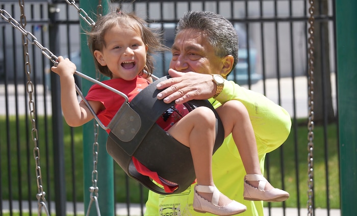 Romulo Gonzalez Rodriguez plays with his 3-year-old daughter Genesis following a interview Tuesday, June 19, 2018, in Provo, Utah. Gonzalez Rodriguez spoke about the anguish of being separated from his 3-year-old daughter, Genesis Gonzalez Lopez, for seven days in November after arriving to the U.S. port of entry in San Diego. Gonzalez Rodriguez said he fled his hometown of Champerico, Guatemala to seek asylum in the United States after he was kidnapped and extorted by captors who cut his eye out and nearly killed him. (AP Photo/Rick Bowmer)