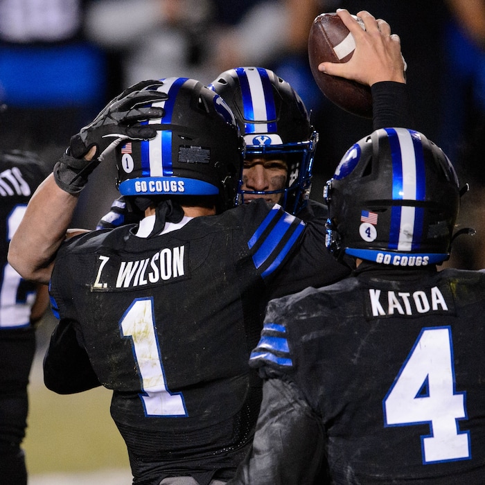 (Trent Nelson | The Salt Lake Tribune) Brigham Young Cougars quarterback Zach Wilson (1) celebrates the win with Brigham Young Cougars linebacker Isaiah Kaufusi (53) and Brigham Young Cougars running back Lopini Katoa (4) as BYU hosts San Diego State, NCAA football in Provo on Saturday, December 12, 2020.