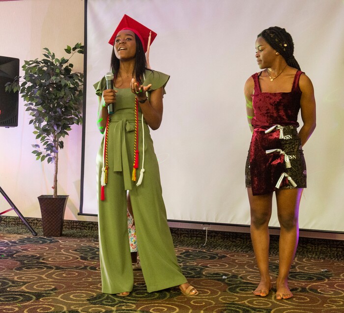 (Rick Egan  |  The Salt Lake Tribune) Academy of Math, Engineering and Science graduate Sylviane Bahati (left) talks about the dress she designed, modeled by her sister Nadine, during a fashion show, graduation celebration. Saturday May 25, 2019