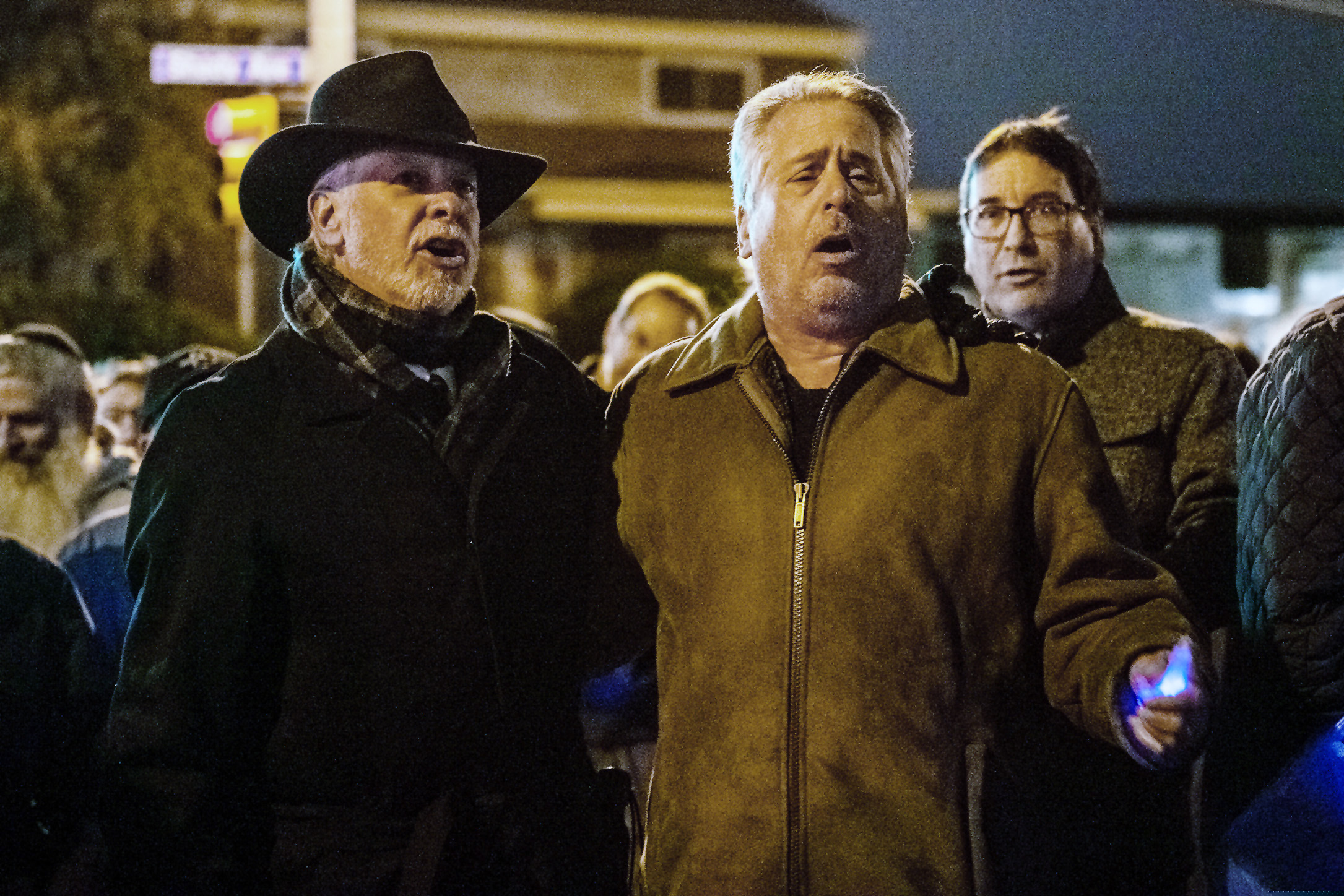 Rabbi Jeffrey Myers, of Tree of Life Congregation, left, and Rabbi Jamie Gibson, of Temple Sinai, lead mourners in song during the six-month anniversary of the Tree of Life mass shooting Saturday, April 27, 2019, in Pittsburgh. The Pittsburgh synagogue that six months ago was the site of the deadliest attack on Jews in U.S. history offered its sympathy after another deadly shooting Saturday at a synagogue near San Diego, saying such violence “must end.” (Michael M. Santiago/Pittsburgh Post-Gazette via AP)