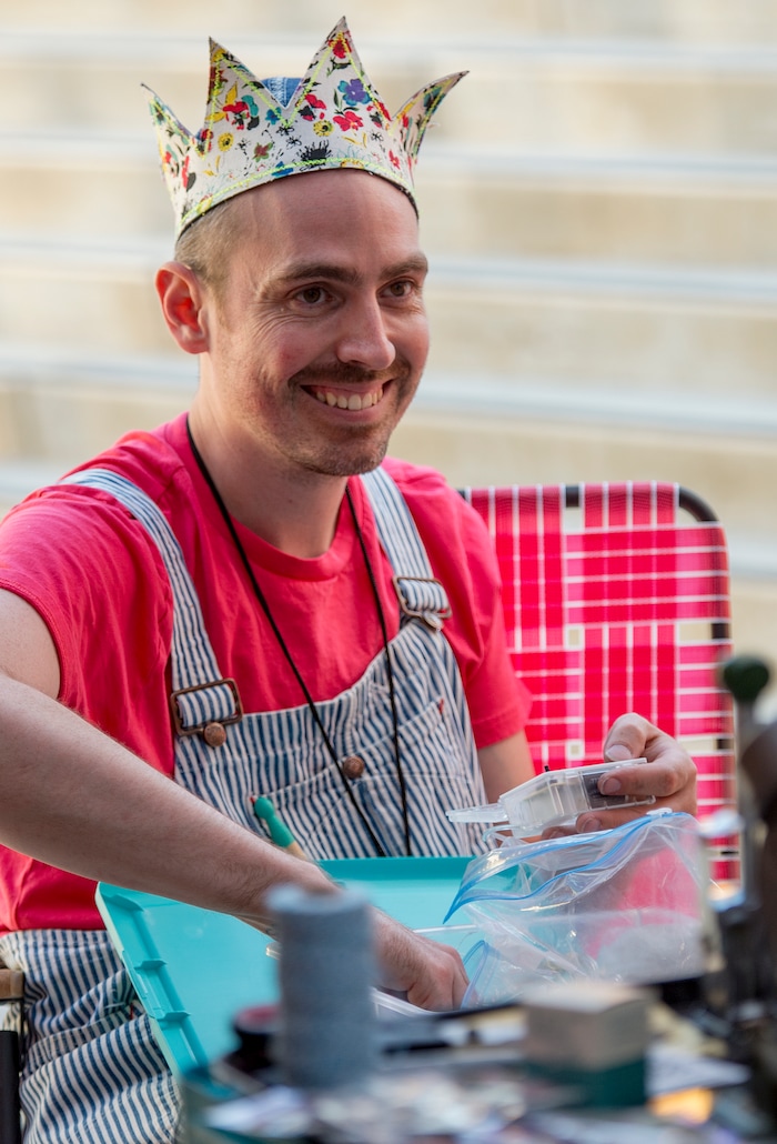 (Leah Hogsten | The Salt Lake Tribune) J. Tyrus Williams, designer at Parker Rose Mercantile fashions a crown as he makes crowns and other wearable art at the 9th Annual Craft Lake City DIY Festival, Friday, August 11, 2017 with over 250 local artisans, DIY engineers, vintage vendors, and craft food creators. The festival also features live music and dance performances, local food trucks and runs through Sunday, August 13th at the Gallivan Center.