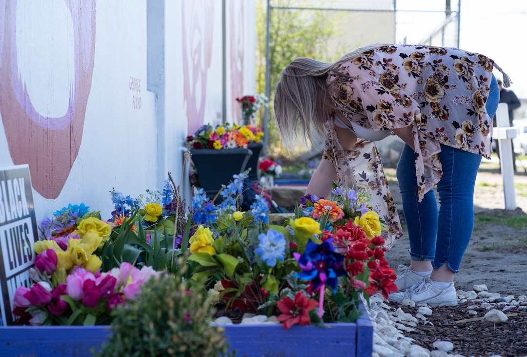 (Francisco Kjolseth  | The Salt Lake Tribune) Shelby Lopez pays her respects at the mural of George Floyd in Salt Lake City as she drops off flowers on Tuesday, April 20, 2021, following the guilty verdict on all three counts in the murder trial of former Minneapolis police Officer Derek Chauvin in the death of George Floyd.
