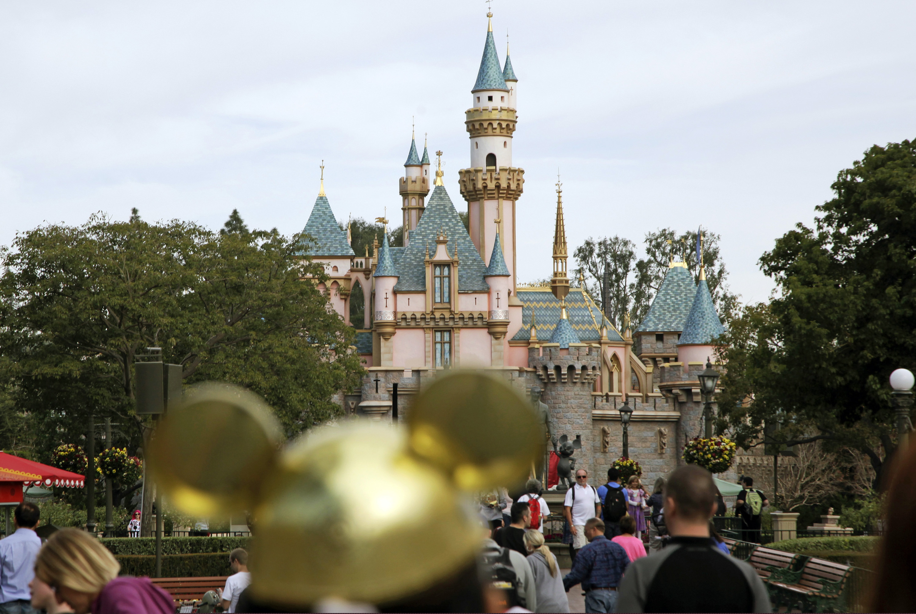 (Jae C. Hong | AP file photo) In this Jan. 22, 2015 photo, visitors walk toward Sleeping Beauty's Castle in the background at Disneyland Resort in Anaheim, Calif.