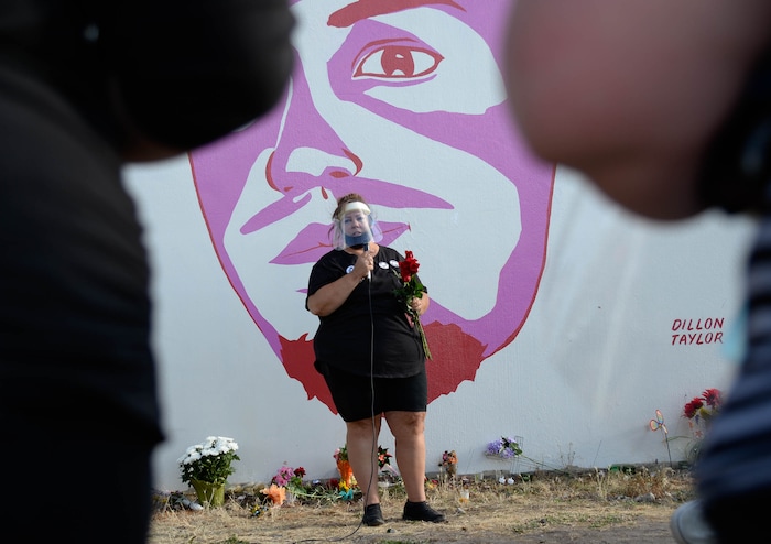 (Francisco Kjolseth  |  The Salt Lake Tribune) Gina Thayne, aunt of Dillon Taylor who raised him, speaks in front of his portrait as people gather for a vigil on the six-year anniversary of Taylor’s death by the murals of people killed by police near 800 South and 300 West in Salt Lake City on Tuesday, August 11, 2020. Multiple families who’s loved one’s are depicted on the walls joined the vigil as they moved from portrait to portrait to remember them.