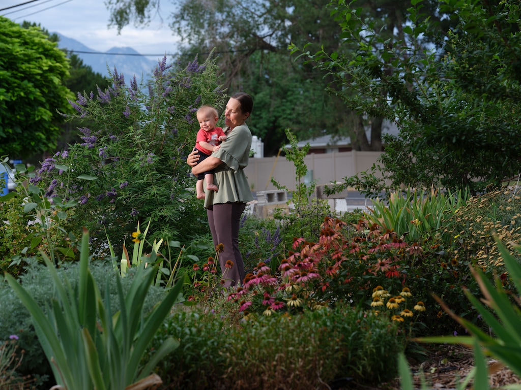(Lindsay D'Addato | The New York Times) Heidi Spence, who waited until she was 38 to have her first child and now has three, holds her son Max at the family's home in Taylorsville, July 22, 2026.