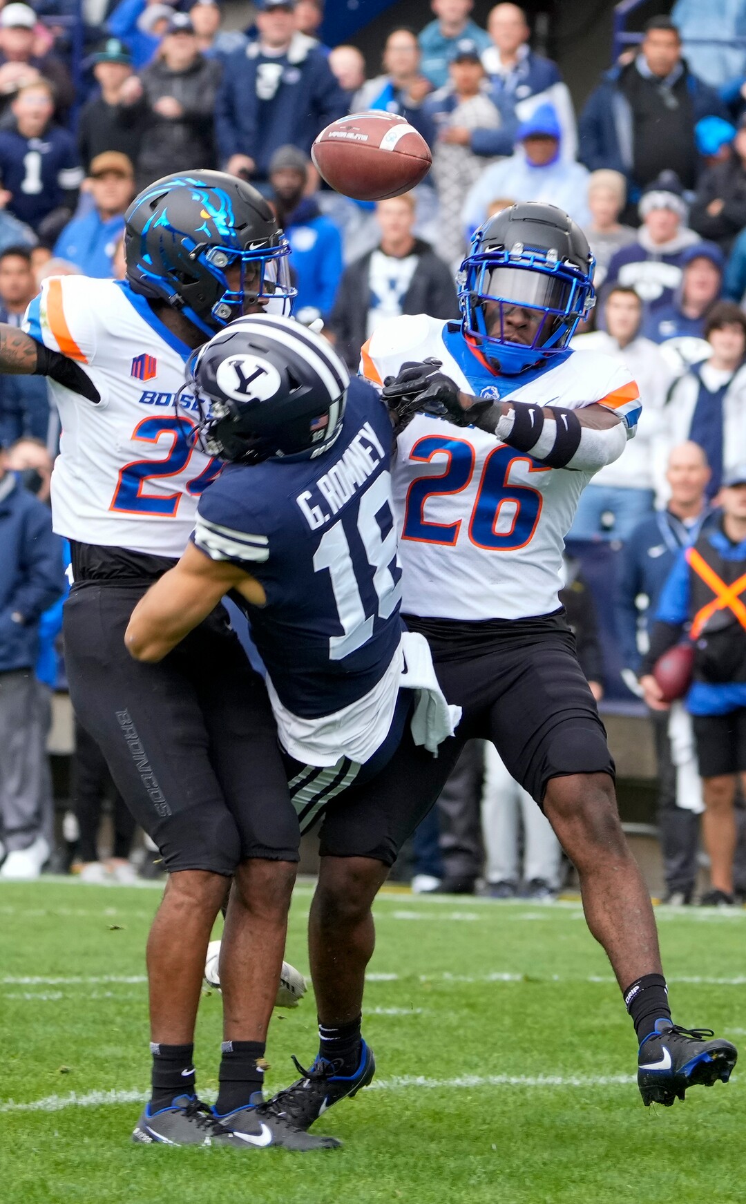 (Leah Hogsten | The Salt Lake Tribune) Brigham Young Cougars wide receiver Gunner Romney (18) gets the ball knocked away by Boise State Broncos cornerback Damon Cole (24) and Boise State Broncos cornerback Caleb Biggers (26) as No. 10 Brigham Young University hosts Boise State at LaVell Edwards Stadium, Oct. 9, 2021.