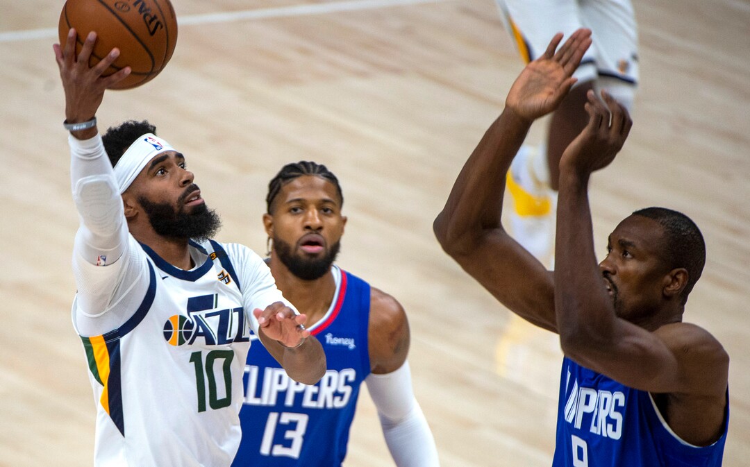 (Rick Egan | The Salt Lake Tribune) Utah Jazz guard Mike Conley (10) takes the ball inside as LA Clippers forward Serge Ibaka (9) defends, in NBA action between the Utah Jazz and the LA Clippers at Vivint Arena, on Friday, Jan. 1, 2021.
