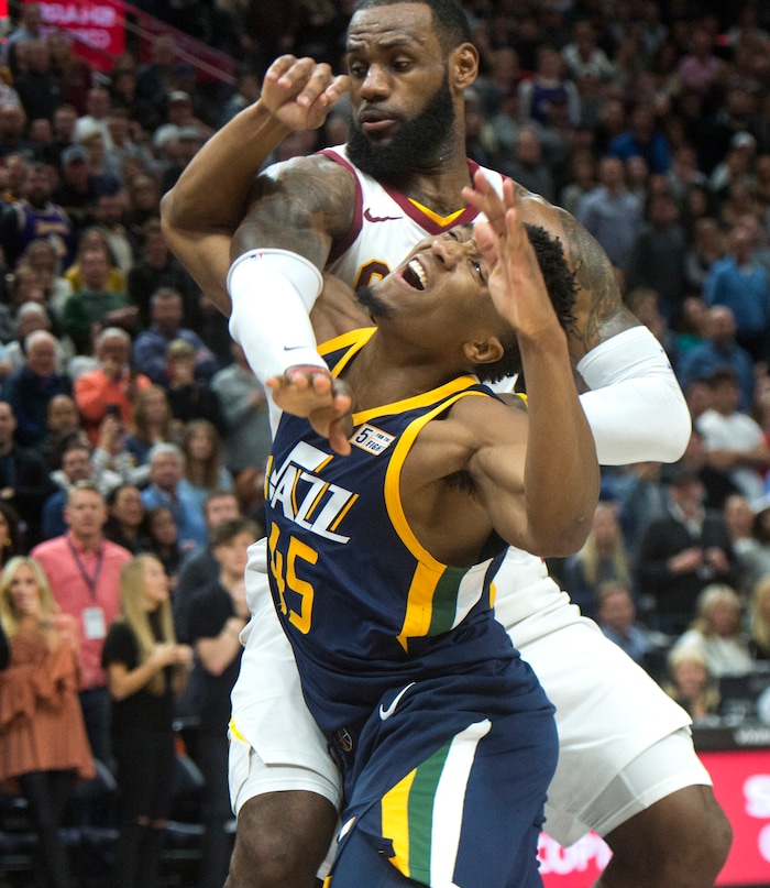 (Rick Egan  |  The Salt Lake Tribune)   Utah Jazz guard Donovan Mitchell (45) is fouled by Cleveland Cavaliers forward LeBron James (23),  as the Cleveland Cavaliers trailed the Utah Jazz 102-99 with 19 seconds left in the game, in NBA action Utah Jazz vs Cleveland Cavaliers, in Salt Lake City,  Saturday, December 30, 2017.


