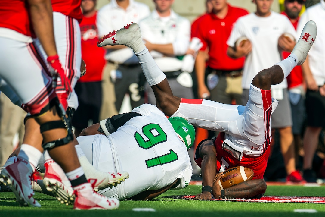 (Chris Detrick  |  The Salt Lake Tribune)  Utah Utes quarterback Tyler Huntley (1) is tackled by North Dakota Fighting Hawks defensive lineman Austin Cieslak (91) during the game at Rice-Eccles Stadium Thursday, August 31, 2017. Utah Utes are leading North Dakota Fighting Hawks 17-9 at halftime. 
