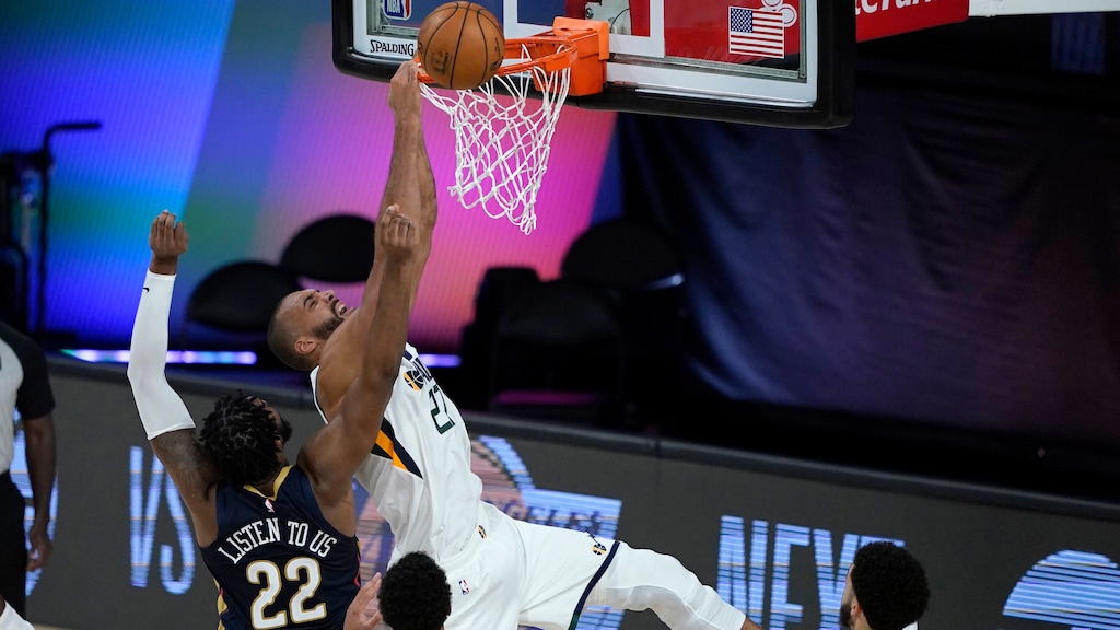 Utah Jazz's Rudy Gobert (27) is unable to score as New Orleans Pelicans' Derrick Favors (22) defends during the second half of an NBA basketball game Thursday, July 30, 2020, in Lake Buena Vista, Fla. (AP Photo/Ashley Landis, Pool)