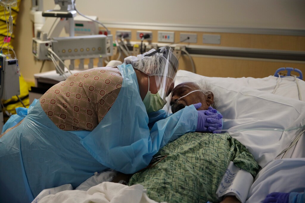 (Jae C. Hong | AP file photo) Romelia Navarro, 64, weeps on July 31, 2020, while hugging her husband, Antonio, in his final moments in a COVID-19 unit at St. Jude Medical Center in Fullerton, Calif. The U.S. death toll from COVID-19 has topped 500,000 — a number so staggering that a top health researchers says it is hard to imagine an American who hasn't lost a relative or doesn't know someone who died.