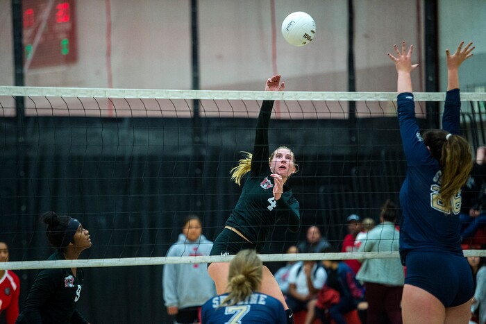 (Chris Detrick | The Salt Lake Tribune) West's Afton WylieÊ(4) spikes the ball past Skyline's Cameron Mooney (26) during the volleyball match at West High School Tuesday, October 3, 2017.
