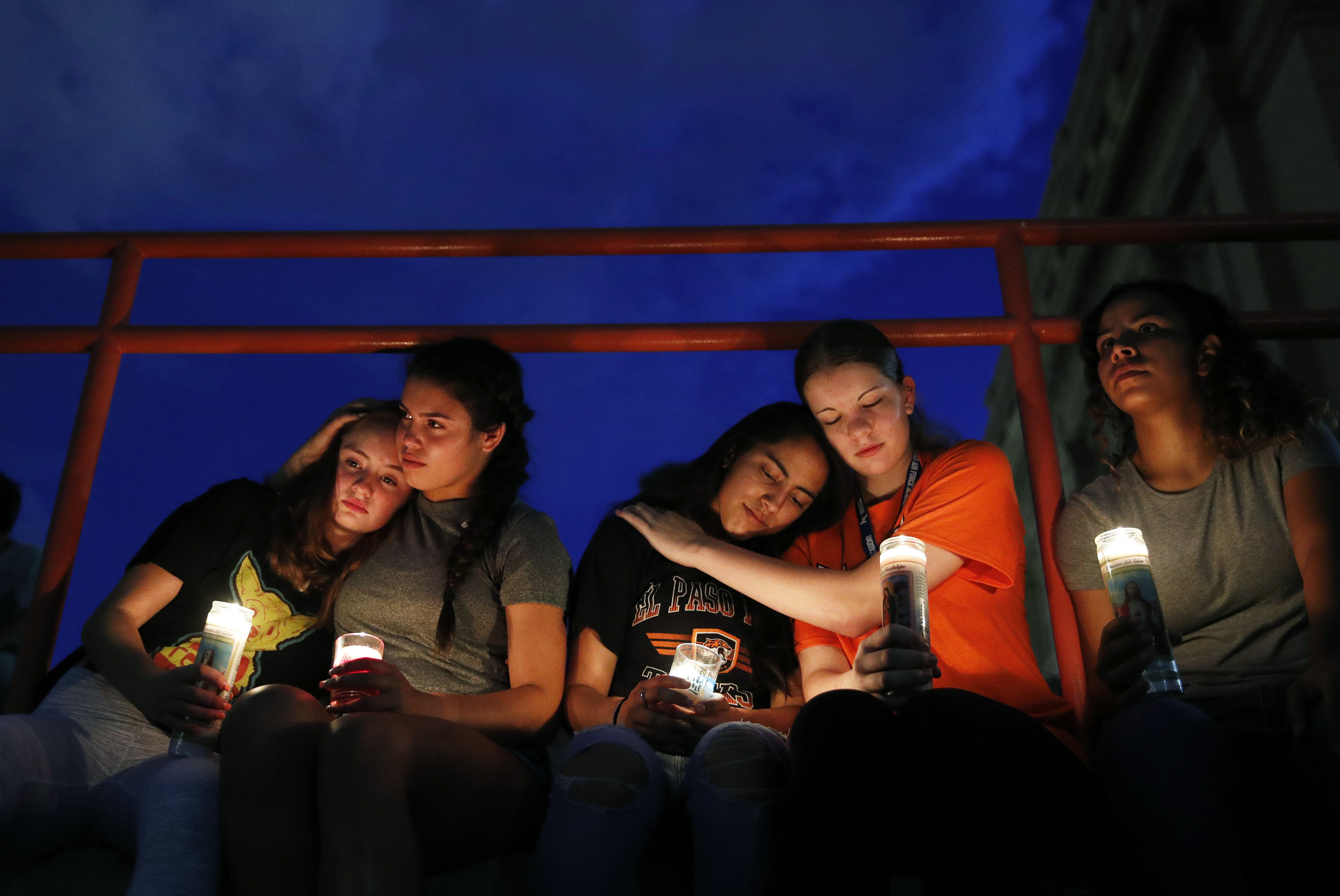 (John Locher | AP Photo) From left, Melody Stout, Hannah Payan, Aaliyah Alba, Sherie Gramlich and Laura Barrios comfort each other during a vigil for victims of the shooting Saturday, Aug. 3, 2019, in El Paso, Texas. A young gunman opened fire in an El Paso, Texas, shopping area during the busy back-to-school season, leaving multiple people dead and more than two dozen injured.