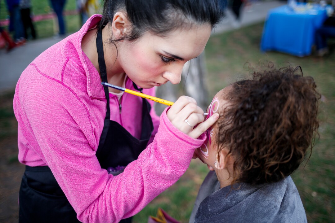 (Nicole Boliaux  |  For The Tribune)  Kailee Brown, left, with My Kids Entertainment  paints Aalyah Laeloni Milline's face during the annual Easter egg hunt put on by A Kid's Place Dentistry in Liberty Park in Salt Lake City on Saturday, March 31, 2018.