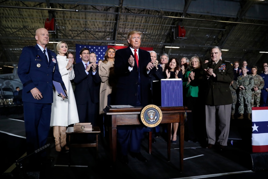 (Andrew Harnik | AP) President Donald Trump applauds after signing the National Defense Authorization Act for Fiscal Year 2020 at Andrews Air Force Base, Md., Friday, Dec. 20, 2019, before traveling to Mar-a-Lago in Palm Beach, Fla.