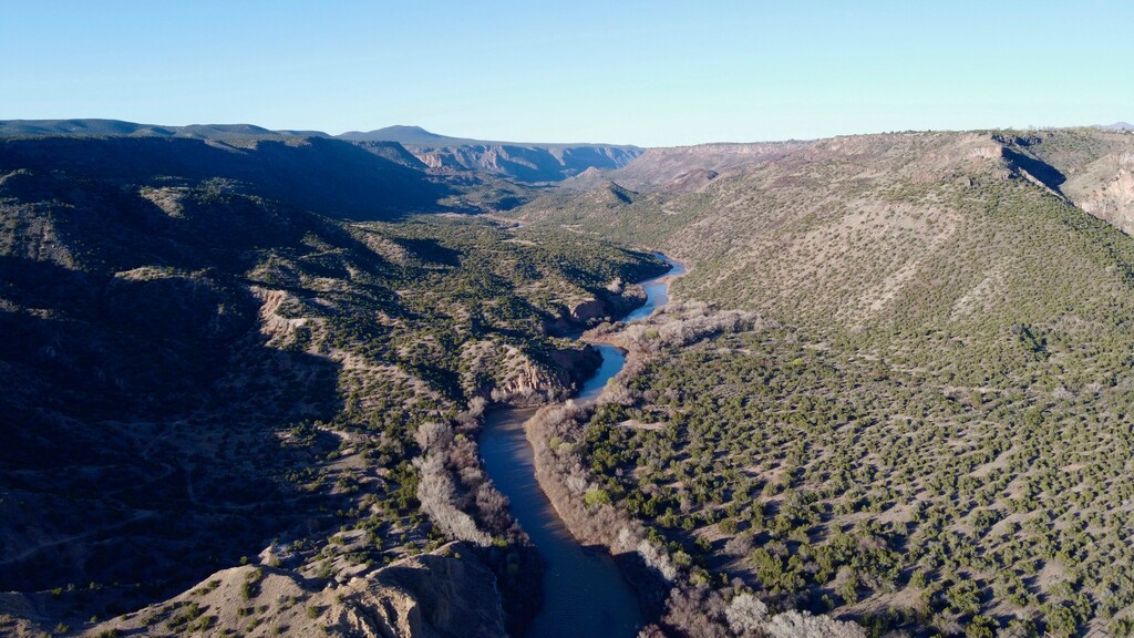 (Galen Hecht | WildEarth Guardians via AP) In this Saturday, April 11, 2020, drone photo provided by WildEarth Guardians, the Rio Grande flows through White Rock Canyon near White Rock, N.M. U.S. forecasters predict spring flows will be less than half of average near the Otowi Bridge gauge and even less downstream, signaling potential trouble for the already stressed waterway.