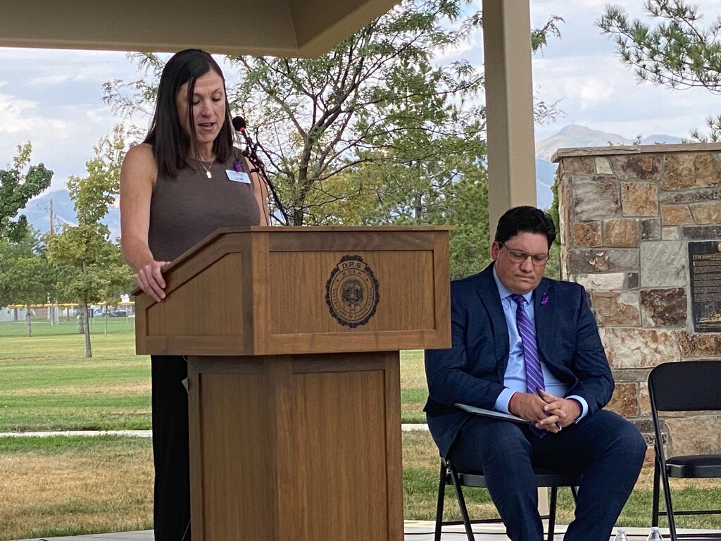 (Sorina Szakacs | The Salt Lake Tribune) Lindsey Boyer, director of South Valley Services, spoke on behalf of advocates for domestic violence victims, at Veterans Memorial Park on Thursday, Aug. 21, 2025. The Utah Department of Public Safety unveiled a dashboard that displays data collected from domestic violence assessments law officers have conducted over the last two years. Rep. Ryan Wilcox, R-Ogden, also spoke at the event.